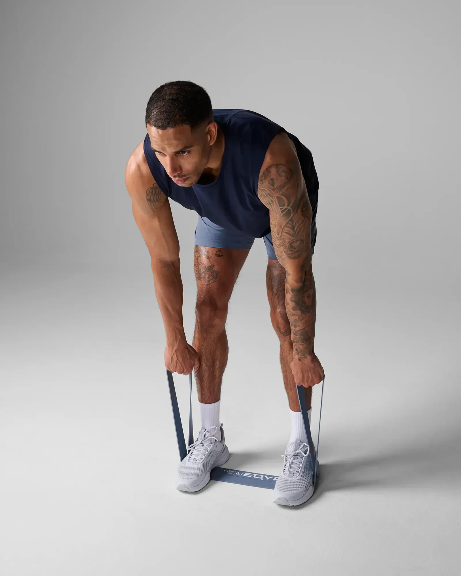 Man performing a deadlift using an EQYP light gray elastic wide super band