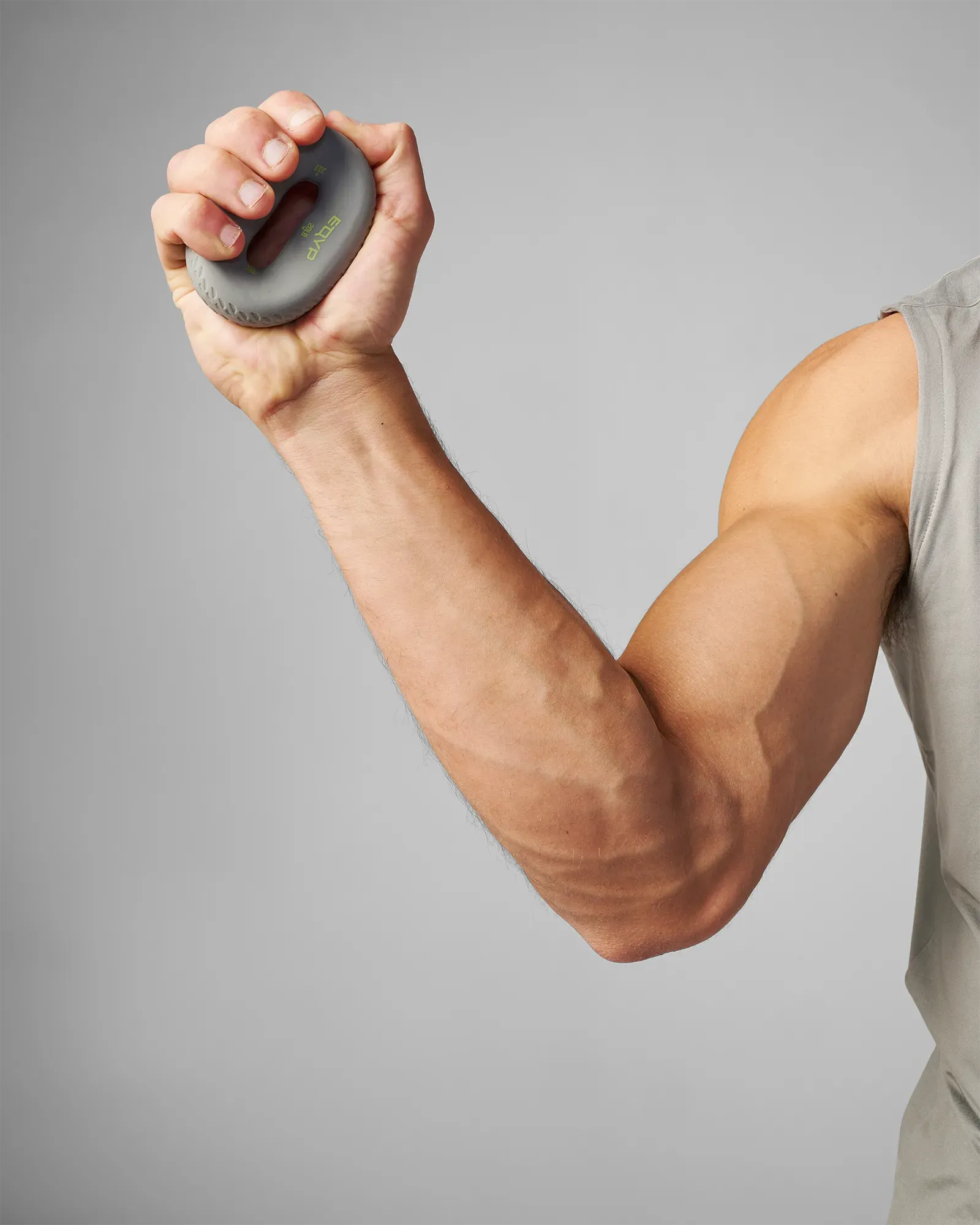 Person holding a gray donut grip against a gray background
