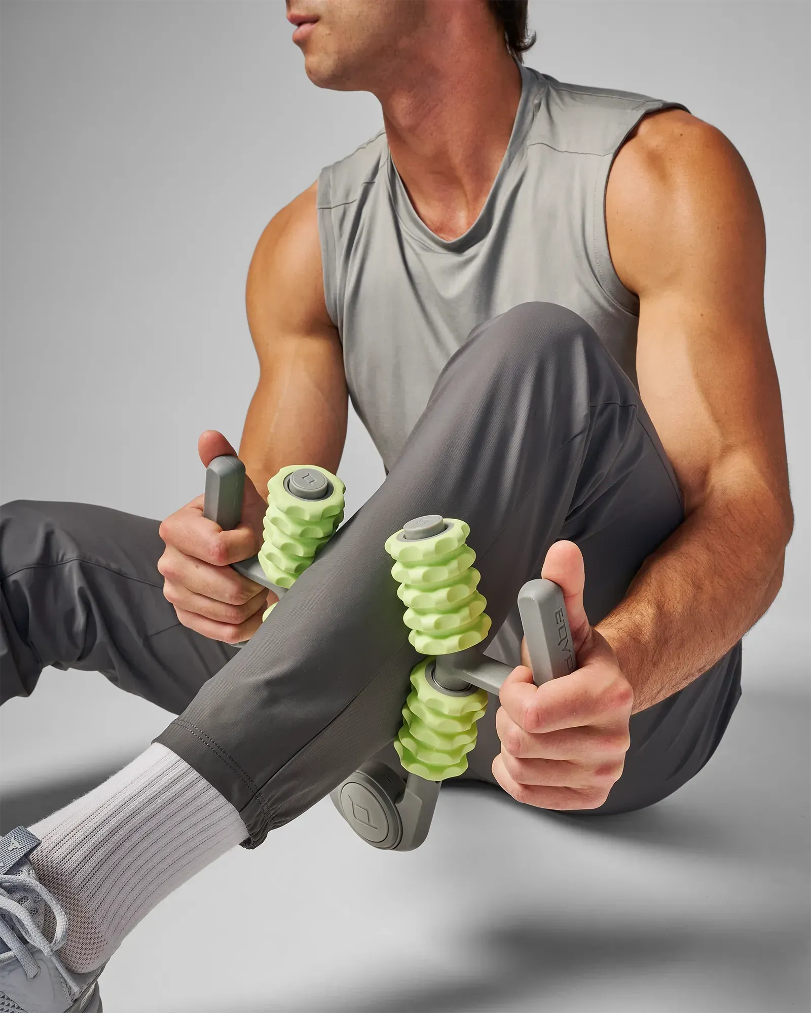 Man using muscle compressor with 4-point massage rollers on his calf