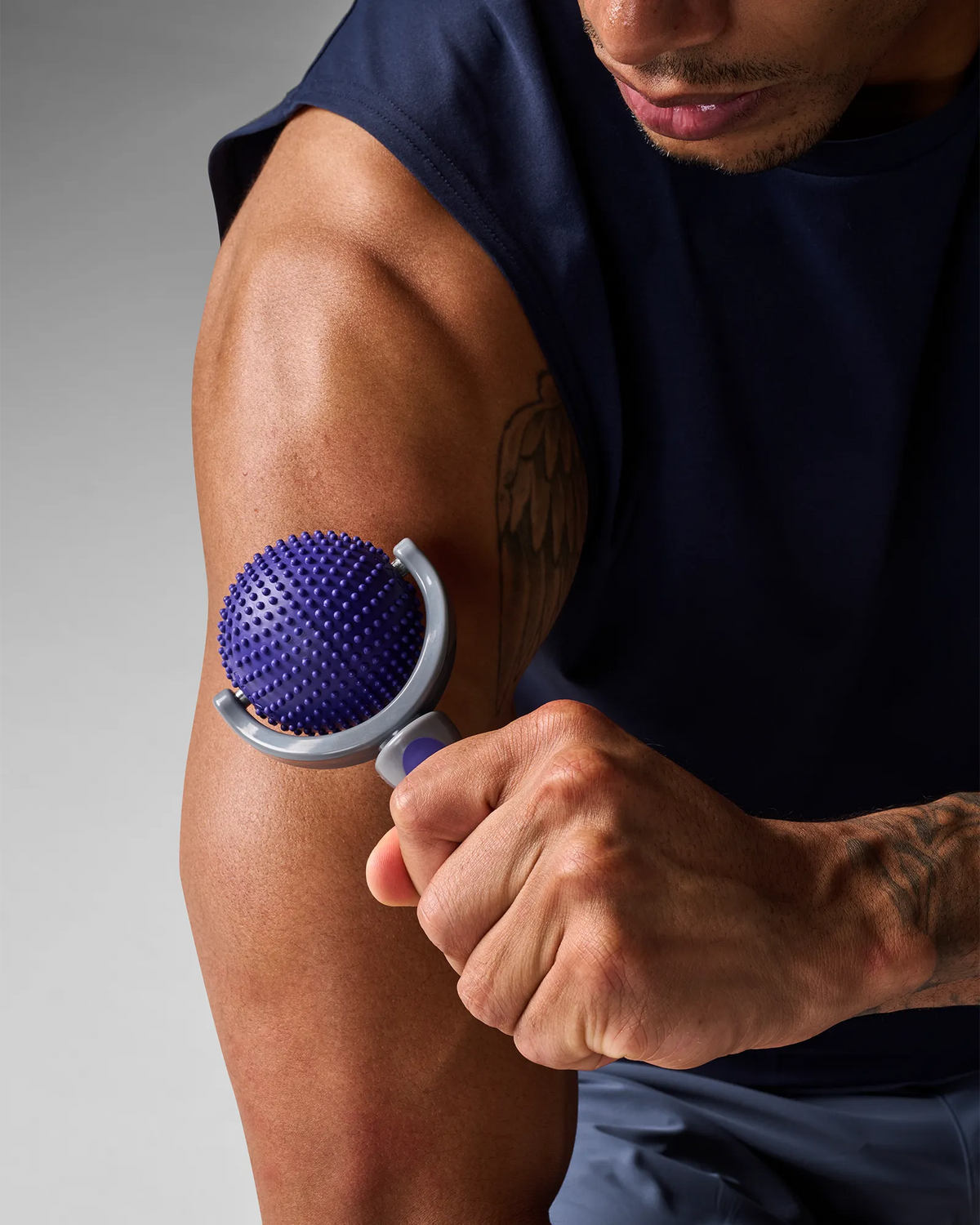 Man using EQYP massage roller on arm for muscle relief