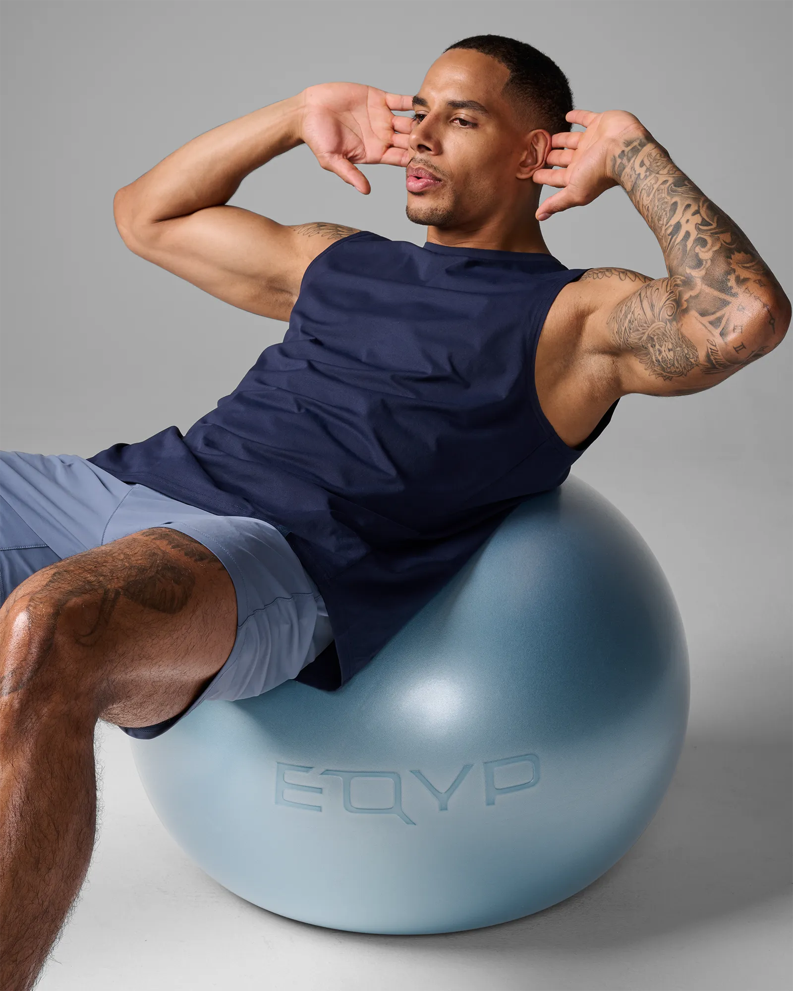 Man performing a stability ball crunch on an EQYP Pro Stability Ball 65cm with lower back supported on the ball