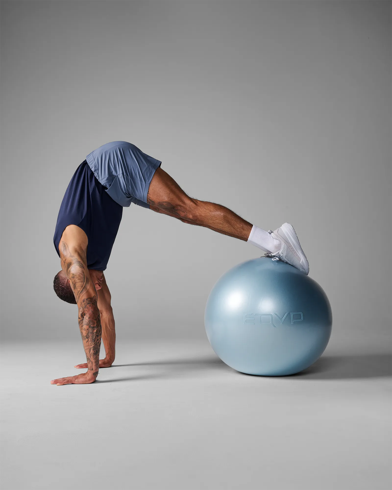 Man performing a stability ball pike on an EQYP Pro Stability Ball 65cm with feet elevated on the ball and hands on the floor