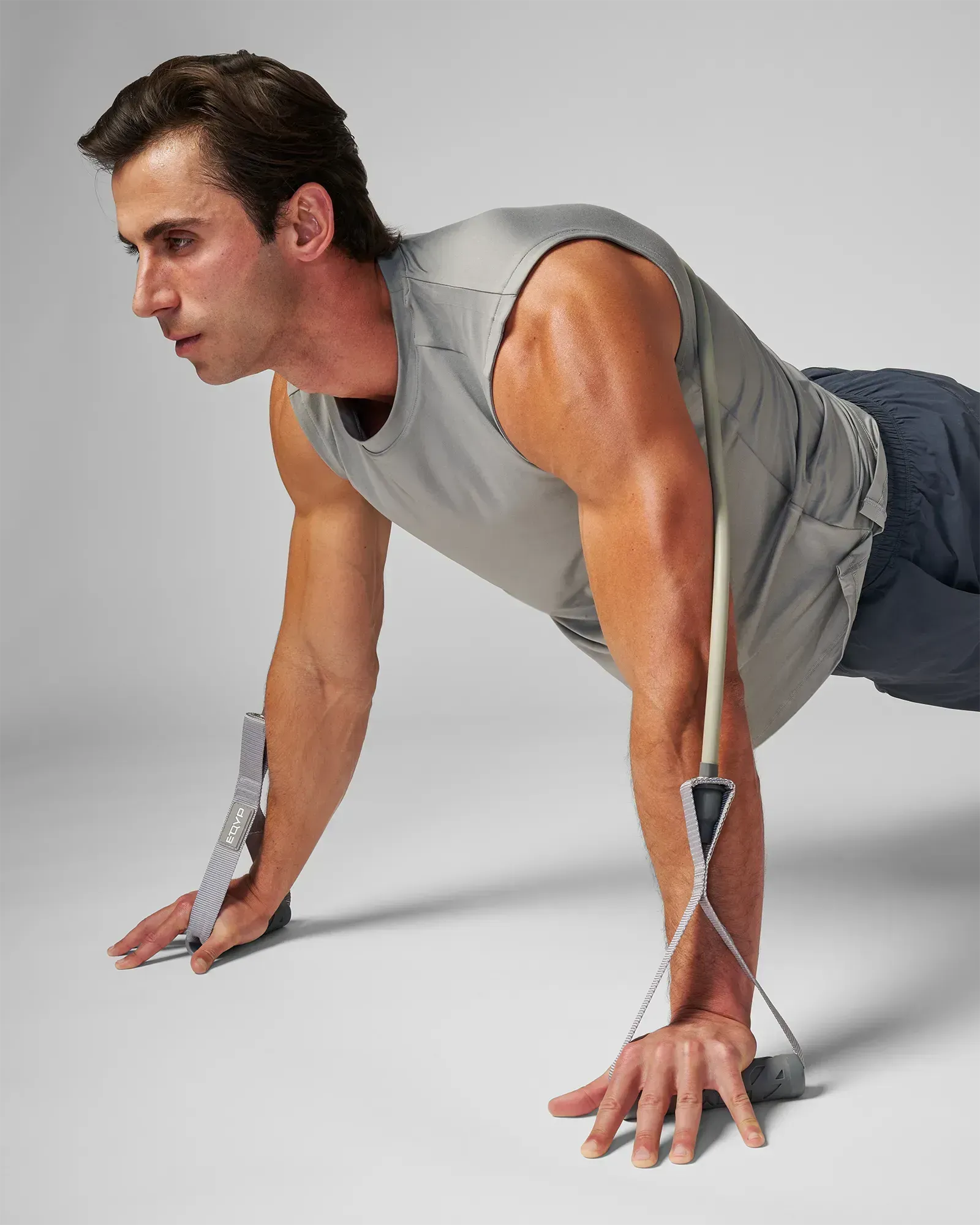 Man performing a push-up position with EQYP Power Tubes with Handles Extra Heavy gray resistance tube