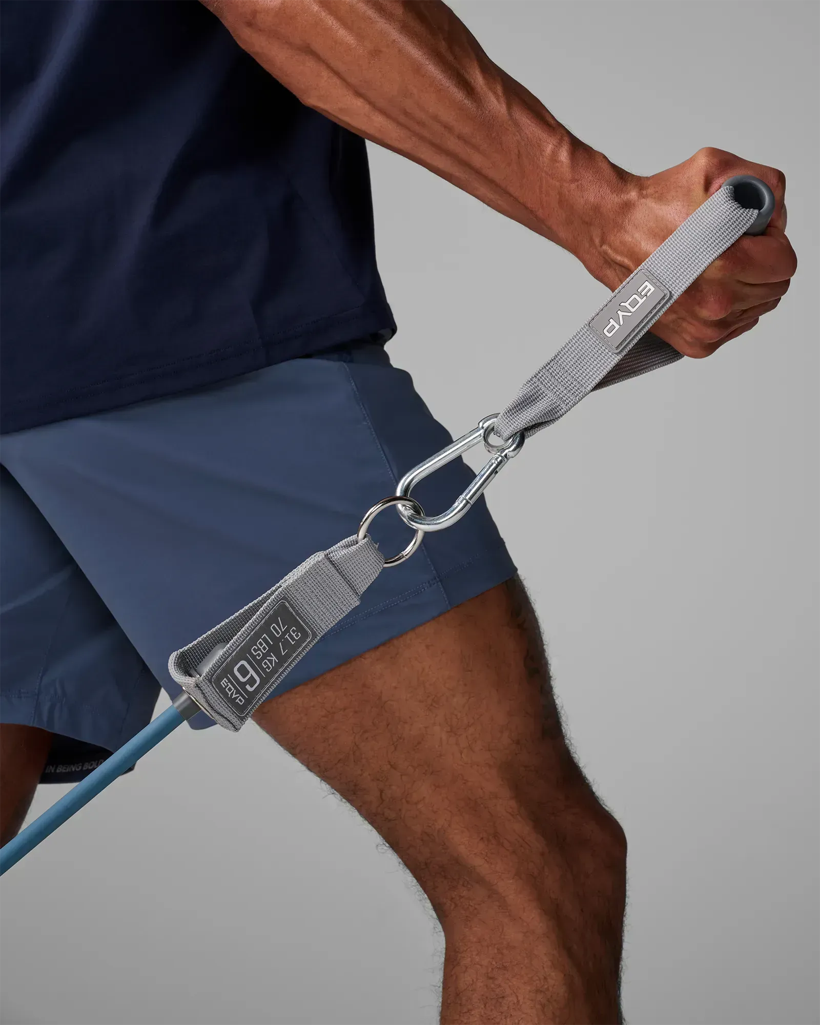 Close-up of EQYP Power Tube 70 lbs gray woven handle with carabiner clip and label reading 31.7 KG / 70 LBS
