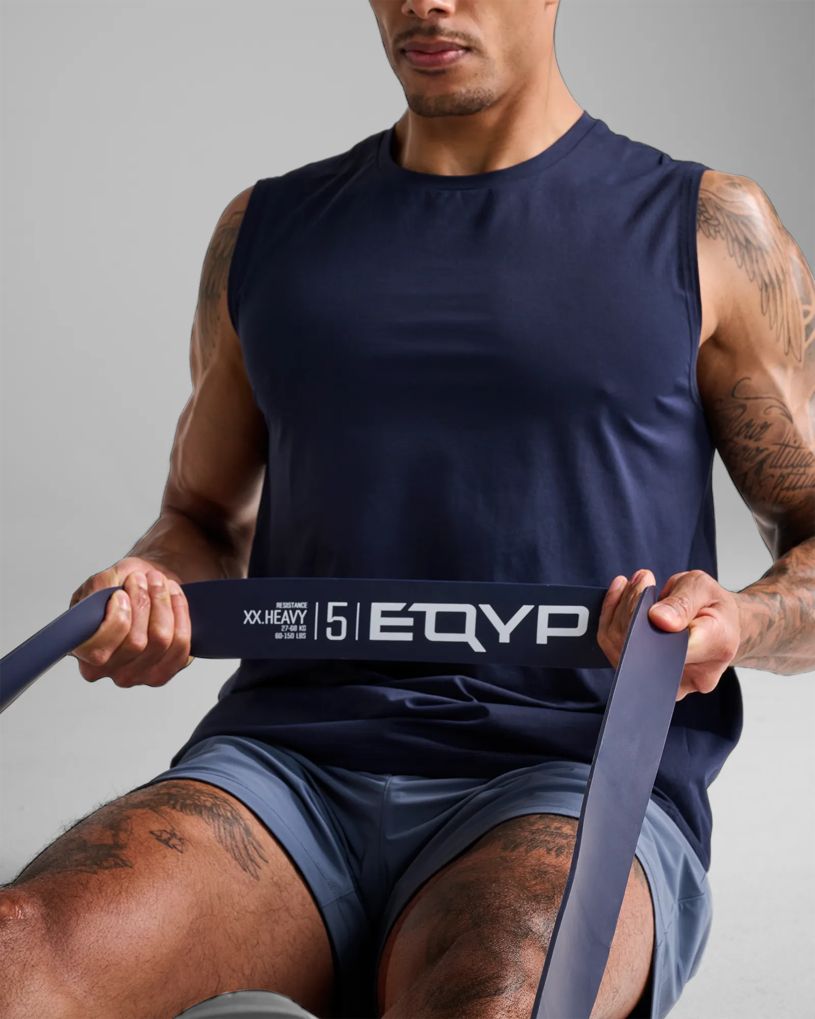 Man performing a seated row using an EQYP dark gray elastic wide super band