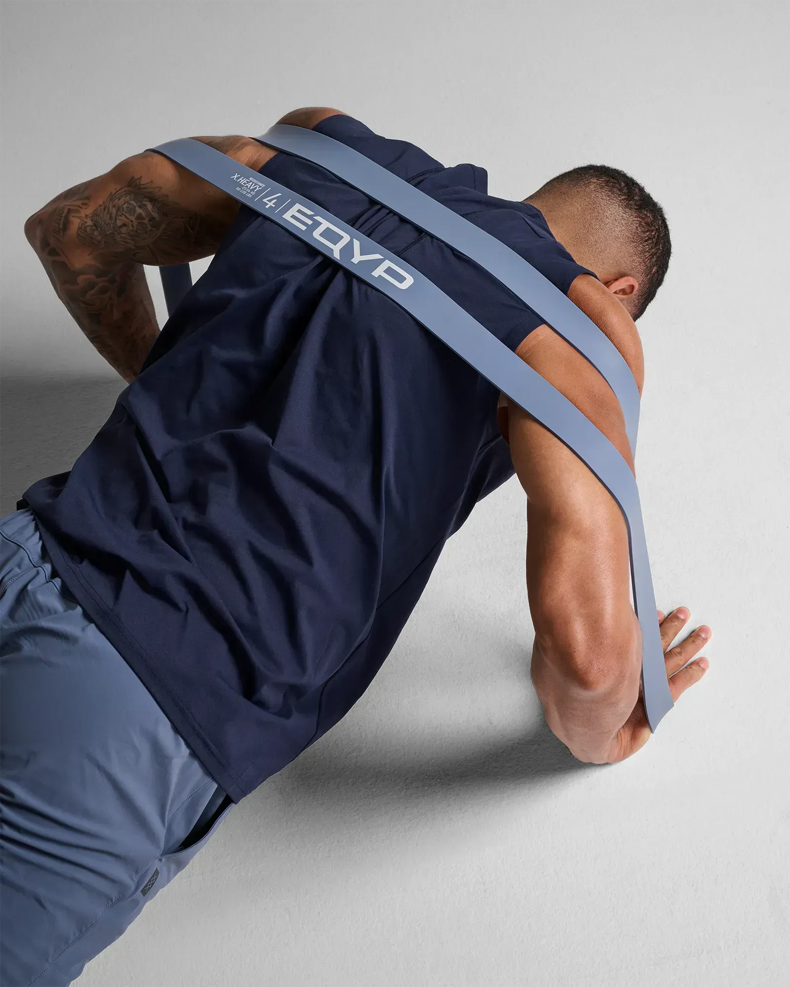 Man performing a push up using an EQYP light gray elastic wide super band