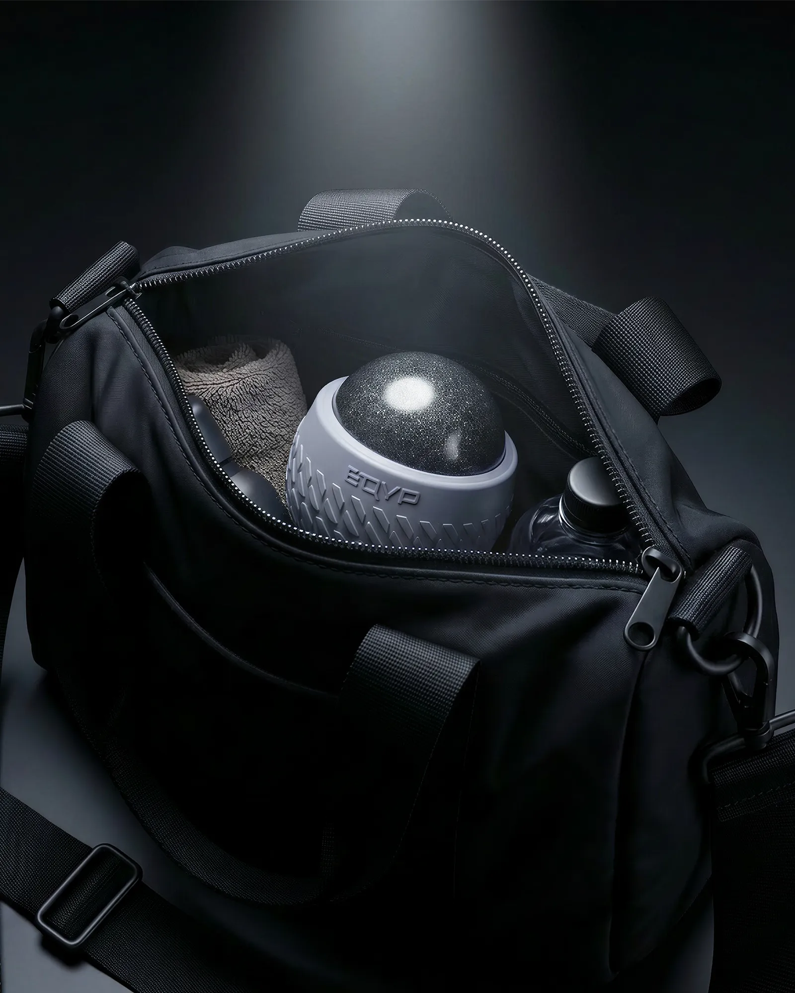 EQYP roll-on massager with textured outer shell in gym bag