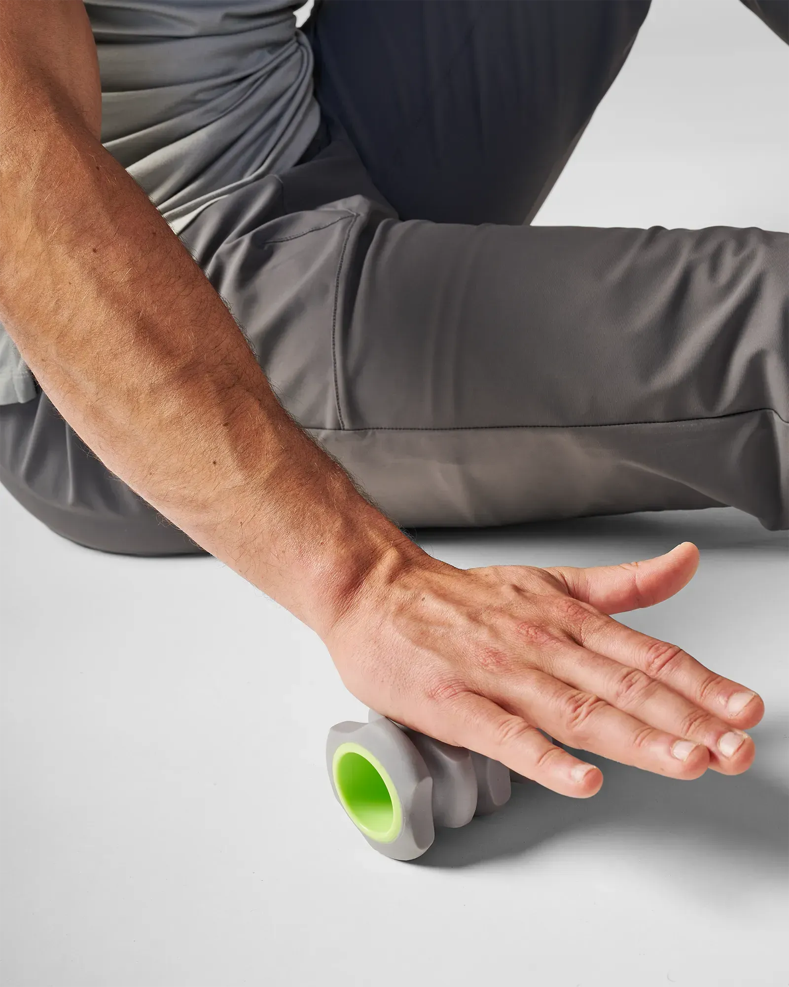Man rolling EQYP Foot and Hand Roller under palm to release hand tension and improve grip recovery after training