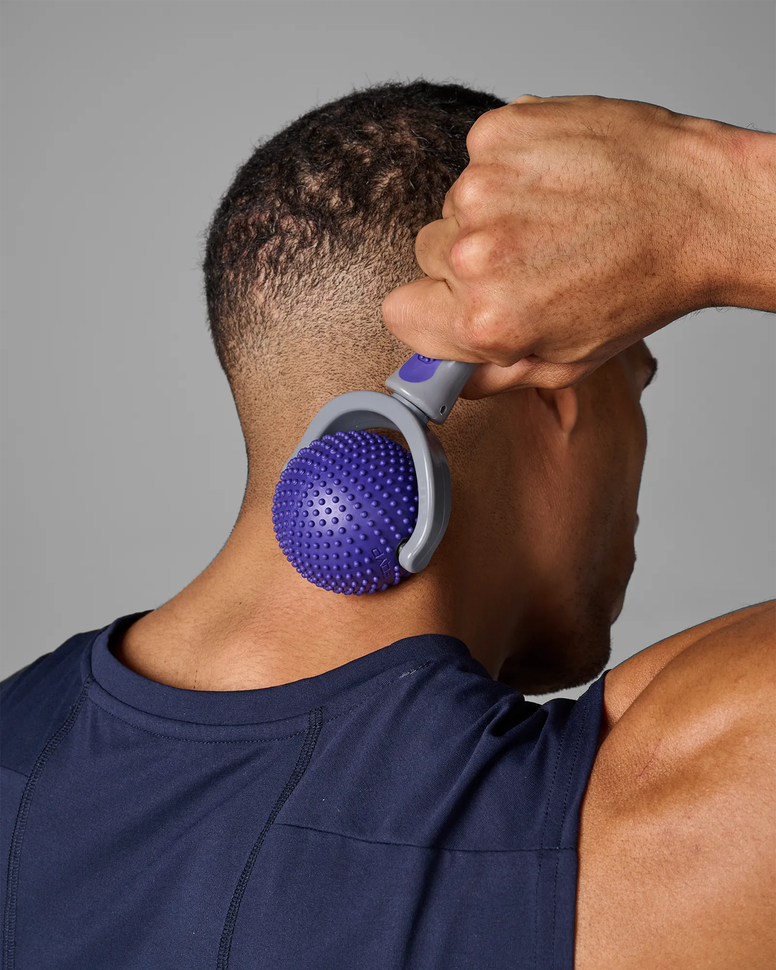 Man using EQYP massage roller on neck for muscle relief