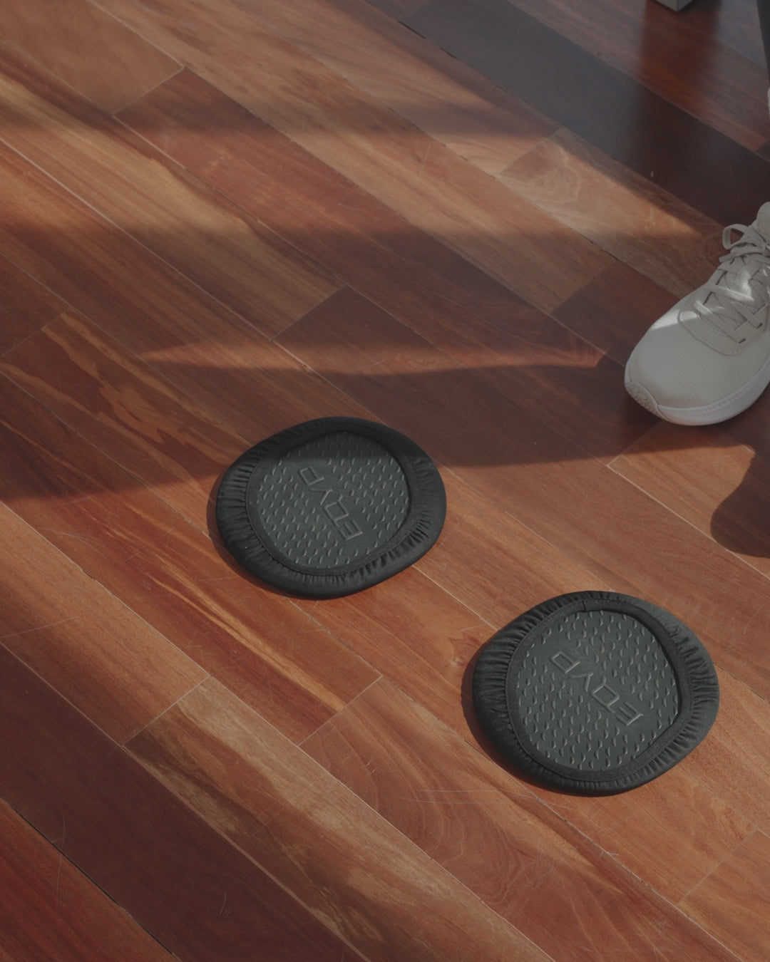 Video of Male and Female Athlete using Sliding Discs to perform different exercises on hardwood floor