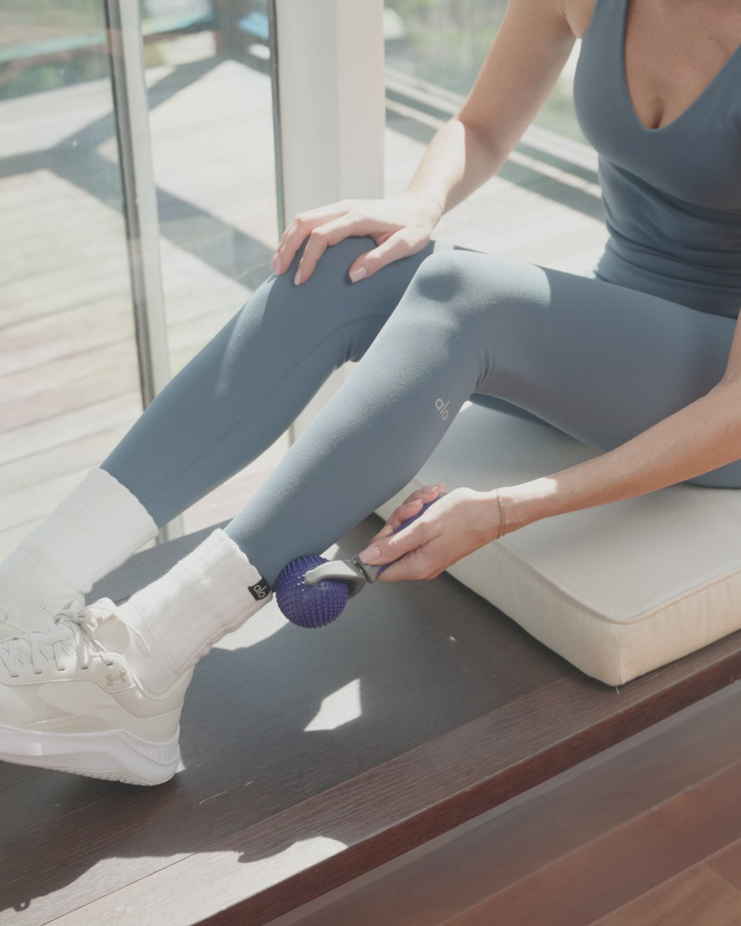 Video of woman using EQYP massage roller on leg for muscle relief