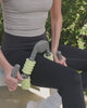 Video of woman using using muscle compressor with 4-point massage rollers on her leg